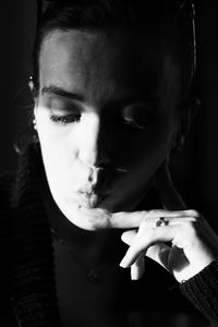 Close-up portrait of man smoking cigarette