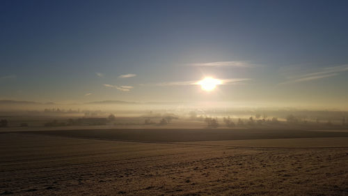 Scenic view of field against sky during sunset