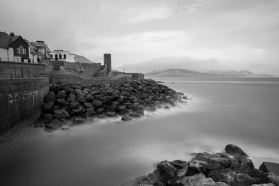 Long exposure of the sea washing up against the rocks at lyme regis in dorest