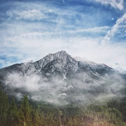 Scenic view of mountains against cloudy sky