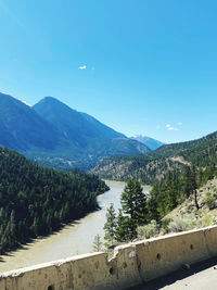 Scenic view of mountains against clear blue sky