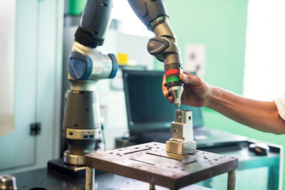 Close-up of man working on metal in factory