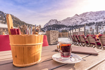 Close-up of black tea on table against mountain