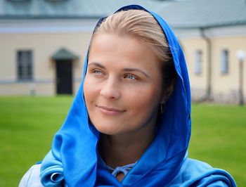 Close-up of thoughtful woman in blue traditional clothing