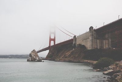 Bridge over sea against sky