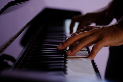 Cropped hand playing piano