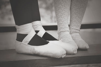 Low section of ballerinas dancing on table