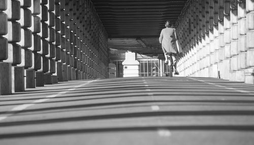 Rear view of man walking on staircase