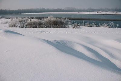 Frozen lake against sky during winter