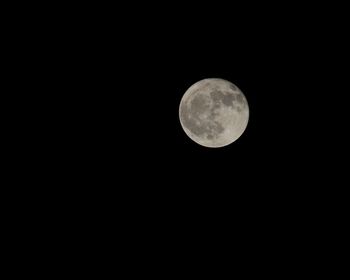 Low angle view of full moon against sky at night