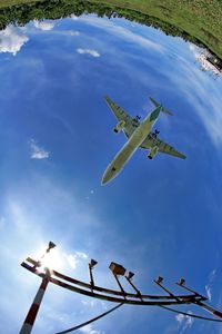 Low angle view of airplane flying against sky