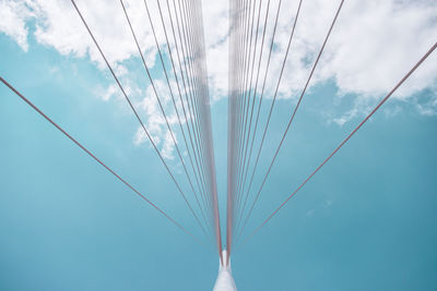 Low angle view of cables against blue sky