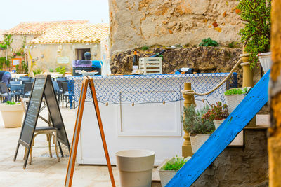 Chairs and table against wall of building