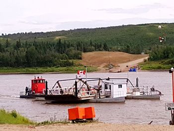 People in boat against sky