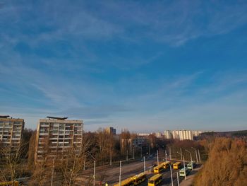 Buildings in city against blue sky