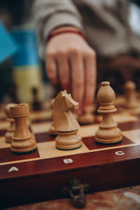 Midsection of man playing chess