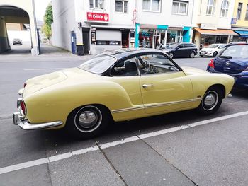 Car parked on street against buildings in city