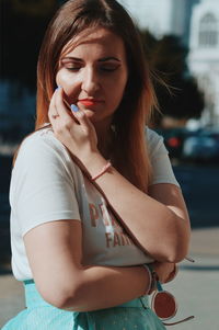 Beautiful woman with eyes closed standing outdoors