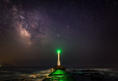 Illuminated landscape against sky at night