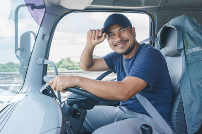 Portrait of man sitting in truck