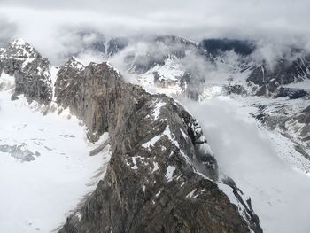 Scenic view of snow covered mountains against sky