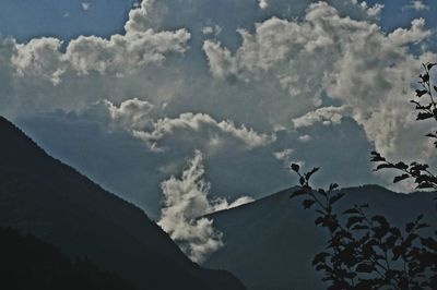 Low angle view of mountain against cloudy sky