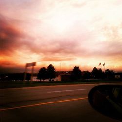 Road against cloudy sky at sunset