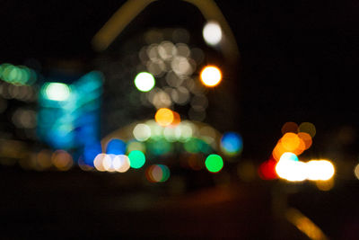 Defocused image of illuminated lights in city at night