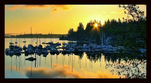 Boats in lake at sunset