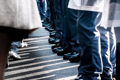 Low section of people walking on road