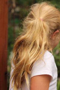 Rear view of woman, girl with long straight ponytail