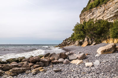 Rocks on beach against sky