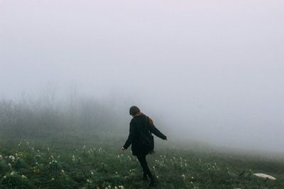 Man standing in foggy weather