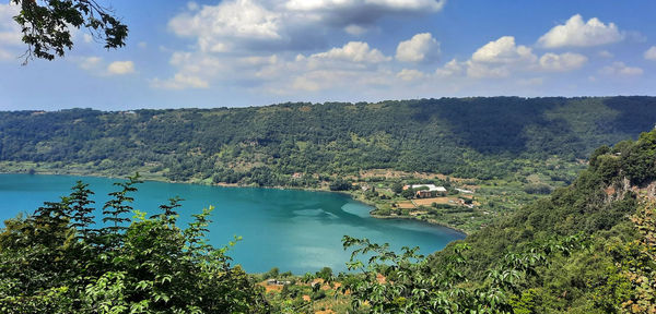 High angle view of lake amidst trees in forest against sky