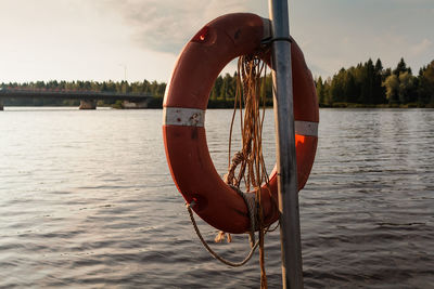 View of fishing boat in lake against sky