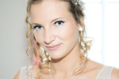 Portrait of smiling woman against white background