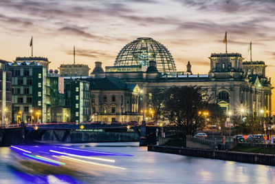 Illuminated buildings against sky at night