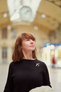 Portrait of a young woman standing outdoors