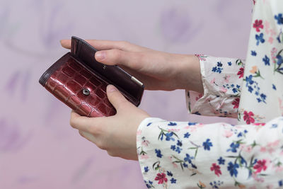 Cropped hands of woman holding wallet