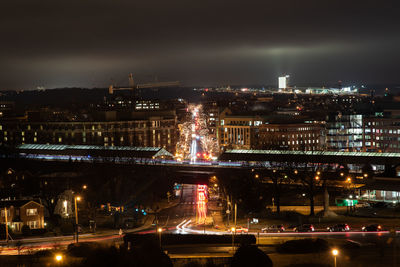 High angle view of illuminated buildings in city at night