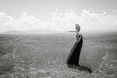 Scenic view of beautiful woman against sky