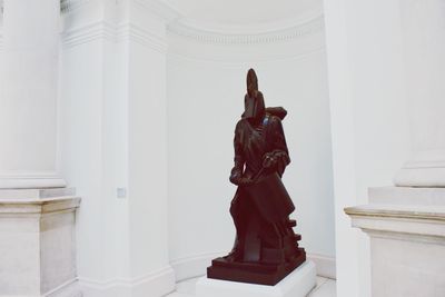 Statue against wall in museum