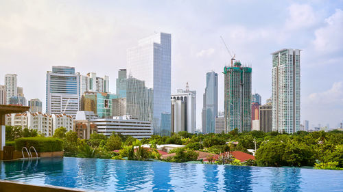 View of skyscrapers against cloudy sky