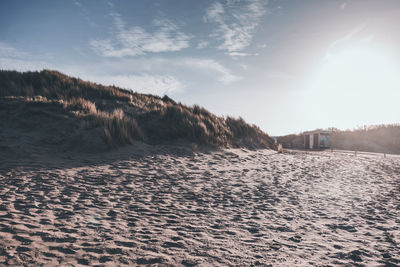 View of sand on beach against sky