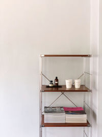 Stack of books on table against wall at home