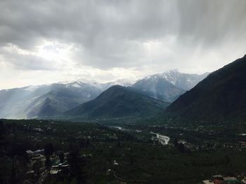 Scenic view of mountains against cloudy sky