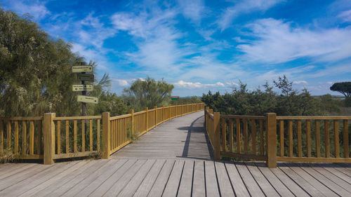 Wooden railing against blue sky