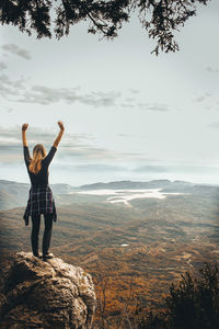 Full length of man standing on rocks at shore