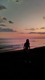 Full length of woman on beach during sunset