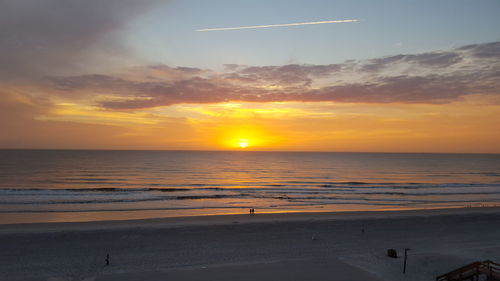 Scenic view of beach against sky during sunset